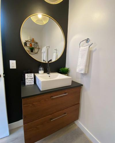 a bathroom with a sink and a mirror at Pax Sacellum Kanab Home for Southern Utah Hiking in Kanab