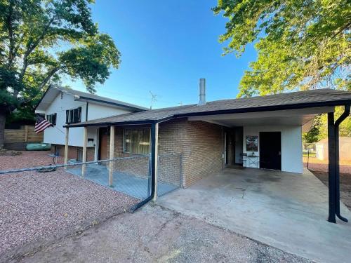 a house with a large driveway in front of it at Pax Sacellum Kanab Home for Southern Utah Hiking in Kanab