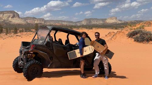 a man and woman standing next to a jeep in the desert at Pax Sacellum Kanab Home for Southern Utah Hiking in Kanab