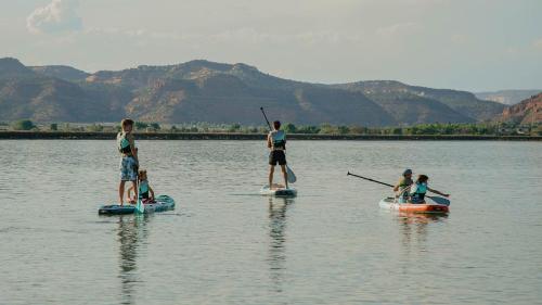 a group of people on paddle boards in the water at Pax Sacellum Kanab Home for Southern Utah Hiking in Kanab