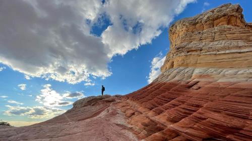 a person standing on the top of a mountain at Pax Sacellum Kanab Home for Southern Utah Hiking in Kanab