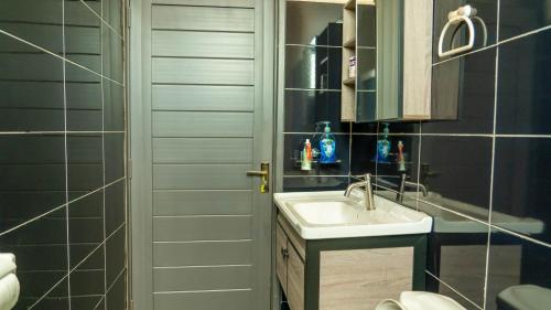 a bathroom with a sink and a toilet at Serene Homes 02 in Kampala