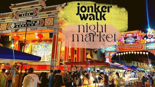 a crowd of people walking around a market at night at Private JACUZZi with Outdoor Cinema 7pax-Jonker 2 bedroom in Malacca