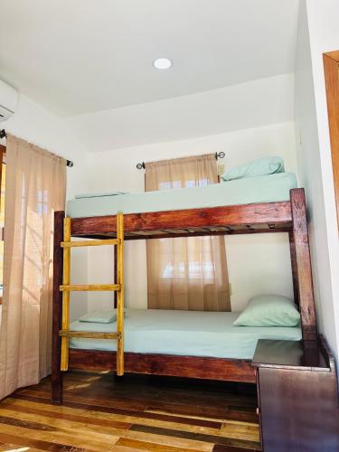 a couple of bunk beds in a room at Silver Sand, Placencia in Placencia Village
