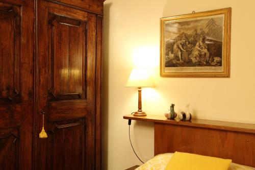 a bedroom with a bed and a painting on the wall at Rovezzano B&B in Florence