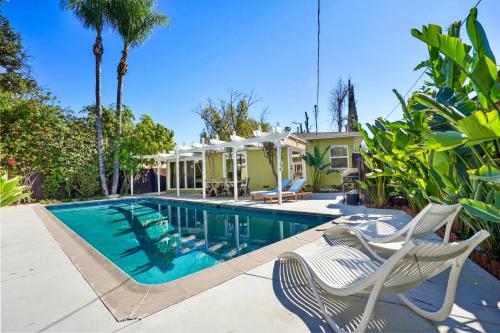 a swimming pool with chairs and a house at Villa La Verde - Newly Designed 4BR Villa with Pool & Guesthouse by Topanga in Los Angeles