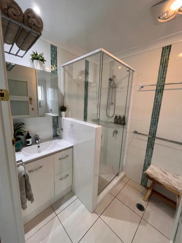 a bathroom with a shower and a sink at Wallawa on Hilltop in Ellesmere