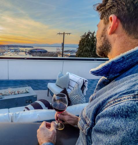 a man holding a glass of wine on a boat at Hot Tub - Best Views - Near Stadiums! in Seattle