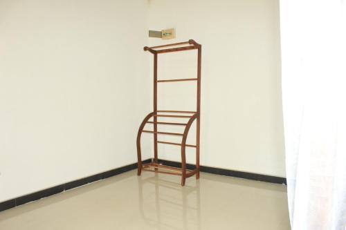 a metal shelf in a room with a white wall at Ehalagala Lake and Paddy view Lodge in Sigiriya