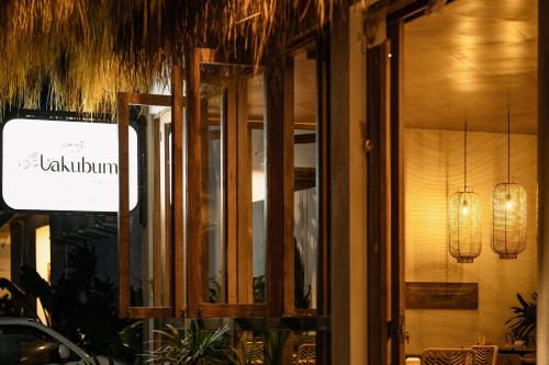 a window of a restaurant with a sign on it at Lakubumi Pavilion in Jimbaran