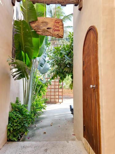 an entrance to a house with a wooden door at Red Sands Mui Ne in Phan Thiet