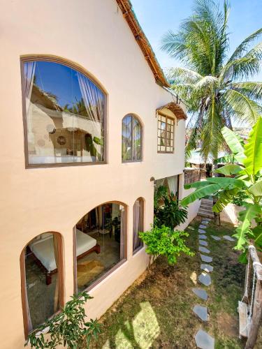 an exterior view of a house with large windows at Red Sands Mui Ne in Phan Thiet