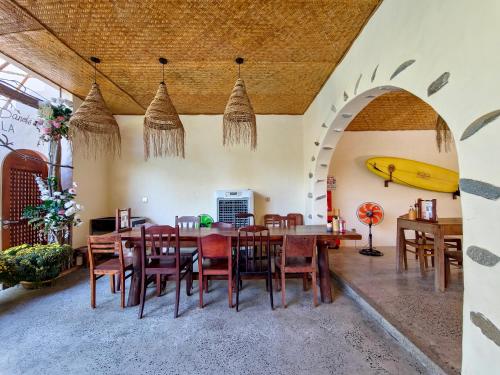 a dining room with a table and a banana on the wall at Red Sands Mui Ne in Phan Thiet