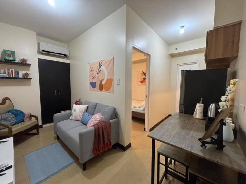 a living room with a couch and a table at Bless View at 16th in Manila