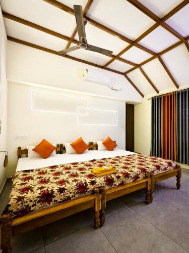 a bedroom with a large bed in a room at Casino Beach Homestay in Alleppey
