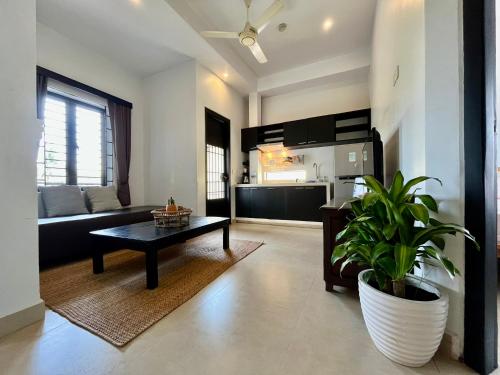 a living room with a couch and a table at Canopy Family Villa in Siem Reap