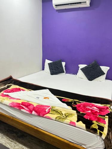 a bedroom with two beds with towels on them at SRI Surya Guest House in Visakhapatnam
