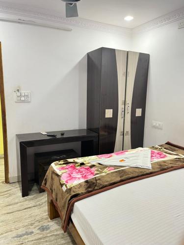 a bedroom with a bed and a dresser in a room at SRI Surya Guest House in Visakhapatnam