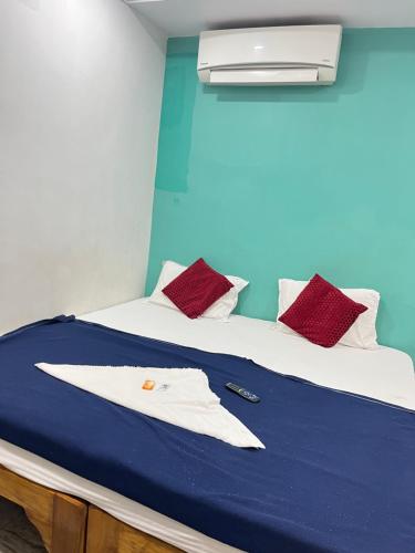 a bedroom with a bed with a white shirt on it at SRI Surya Guest House in Visakhapatnam