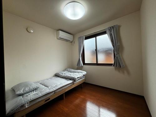 Cama o camas de una habitación en 風車村貸別荘3-R-1daito