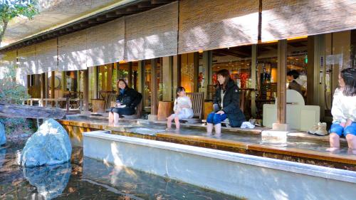 a group of people sitting in front of a building at Magma Resort Yamanashi in Minobu