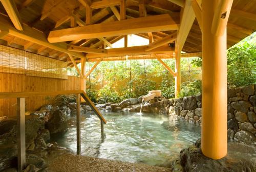 a pool of water under a wooden structure at Magma Resort Yamanashi in Minobu