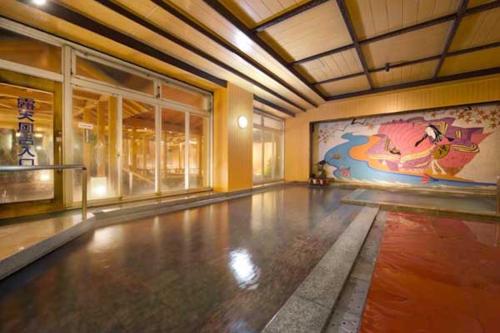 a room with a painting on the wall and a dance floor at Magma Resort Yamanashi in Minobu