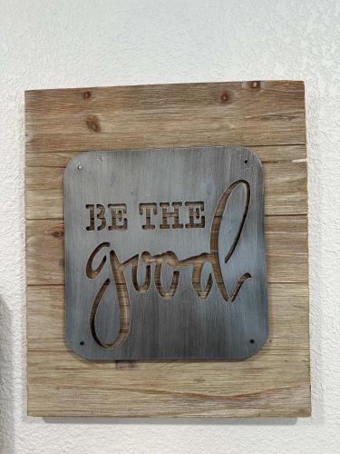 a sign that says be the guest on a wall at Adorable New West 3 BR 2 BA SMRT TV Coffee in Wichita