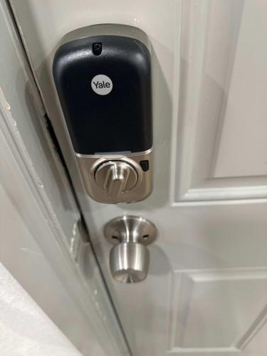 a door with a cell phone sticking out of it at Adorable New West 3 BR 2 BA SMRT TV Coffee in Wichita