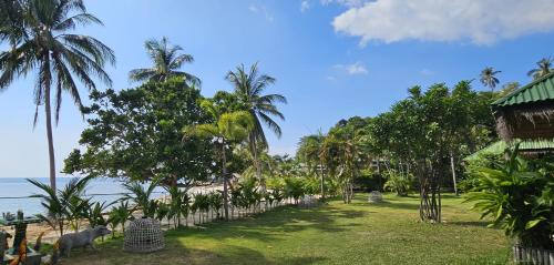 a view of the beach from a resort with palm trees at Sense Asia in Haad Tian