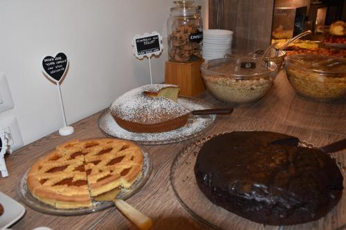 a wooden table with pies and waffles on it at Il Belvedere in Matera