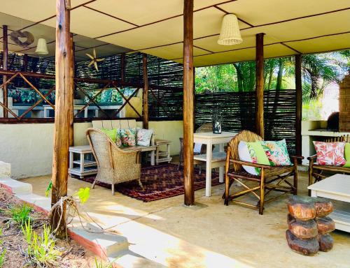 a pavilion with chairs and a table on a patio at Lidiko Lodge in St Lucia