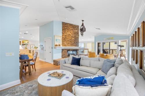 a living room with a couch and a fireplace at Anchored Here home in Captiva