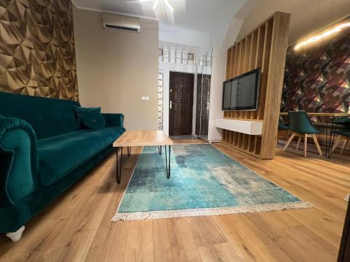 a living room with a green couch and a table at Urban Waves with 2 bedrooms and terace in Constanţa