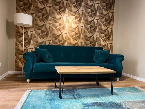 a living room with a green couch and a table at Urban Waves with 2 bedrooms and terace in Constanţa