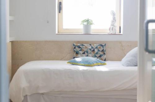 a bed with a pillow on top of it at Exclusive Seafront Villa,Private Pool,Gym,BBQ in El Toro