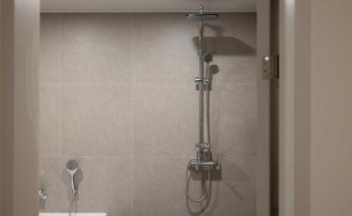 a shower in a bathroom with a glass door at Koum Ryokan Hotel Gijang by Aank in Busan
