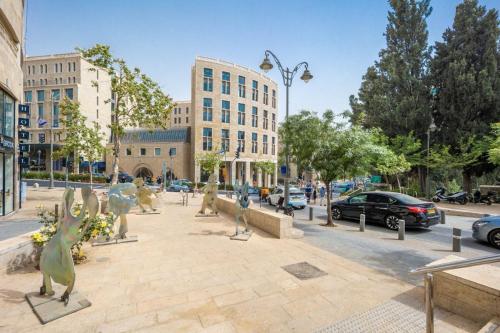 a street with statues of birds on a sidewalk at Mamilla view URBAN - Boutique hotel in Jerusalem