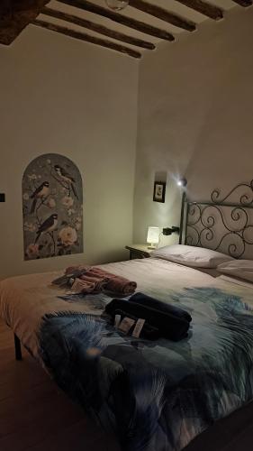 a bedroom with a bed with a bag on it at Dolce Dimora Siena in Siena