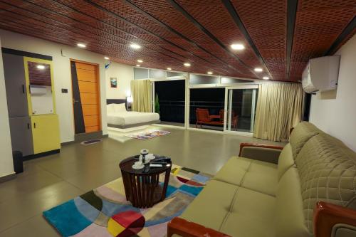 a living room with a couch and a table at The Cozy Winterfell in Munnar