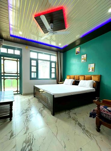 a bedroom with a large bed in a room with green walls at Nature's Retreat Homestay in Mugāra