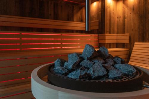 a pile of rocks in a fire pit in a room at Hotel Die Post in Bad Kleinkirchheim