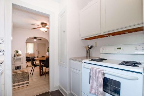 a kitchen with white cabinets and a stove top oven at Home Sweet Home - Loft 3 BR - 1 BA WIFI SMART TV in Wichita