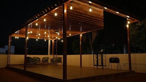 a pavilion with lights and a table and chairs at Kuteeram - Create Memories in Secunderabad