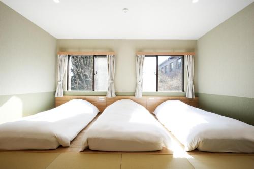 Una cama o camas en una habitación de Grand Lectore Yugawara - TKP Hotels & Resorts