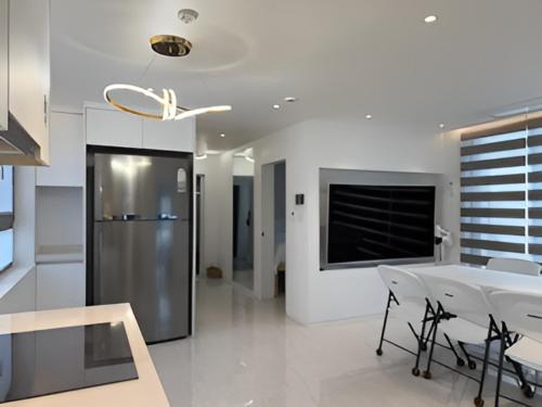 a kitchen and dining room with a table and a refrigerator at 318 Stay in Seoul