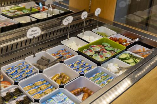 a buffet line with trays of different types of food at AKZENT Hotel Restaurant Roter Ochse Rhens bei Koblenz in Rhens