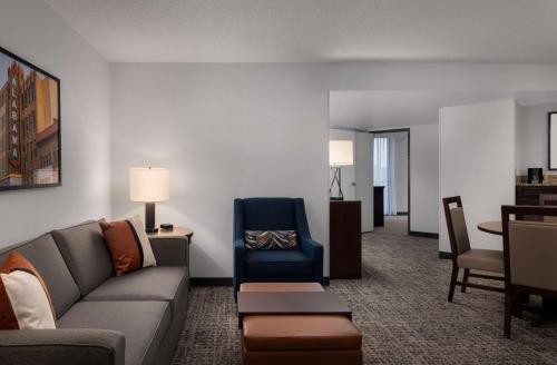 a living room with a couch and a chair at Embassy Suites Birmingham in Birmingham