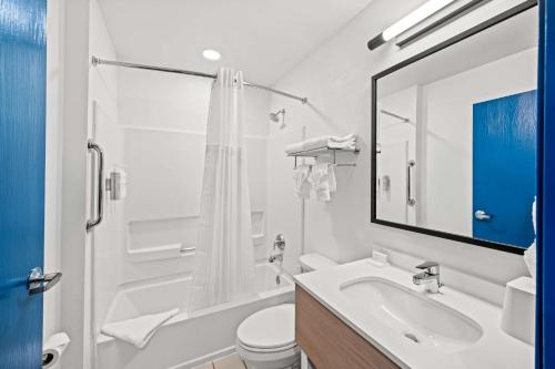 a white bathroom with a sink and a toilet at Spark by Hilton Sterling Dulles Airport in Sterling