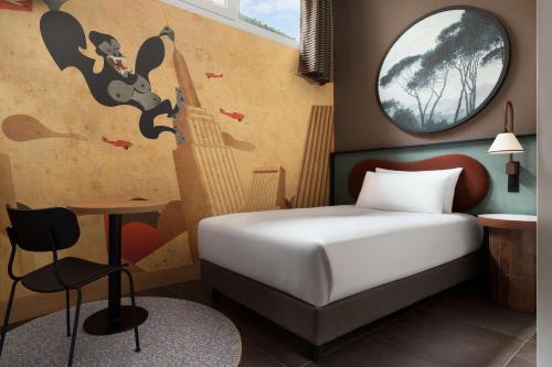 a hotel room with a bed and a mouse on the wall at The Spring House Hotel Rome Vatican, Tapestry Collection Hilton in Rome